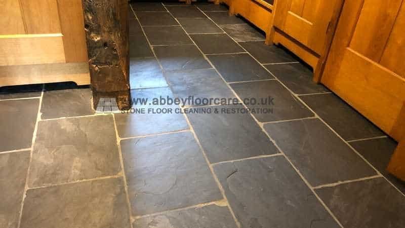 Slate floor after old coating removal showing cleaner texture before sealing